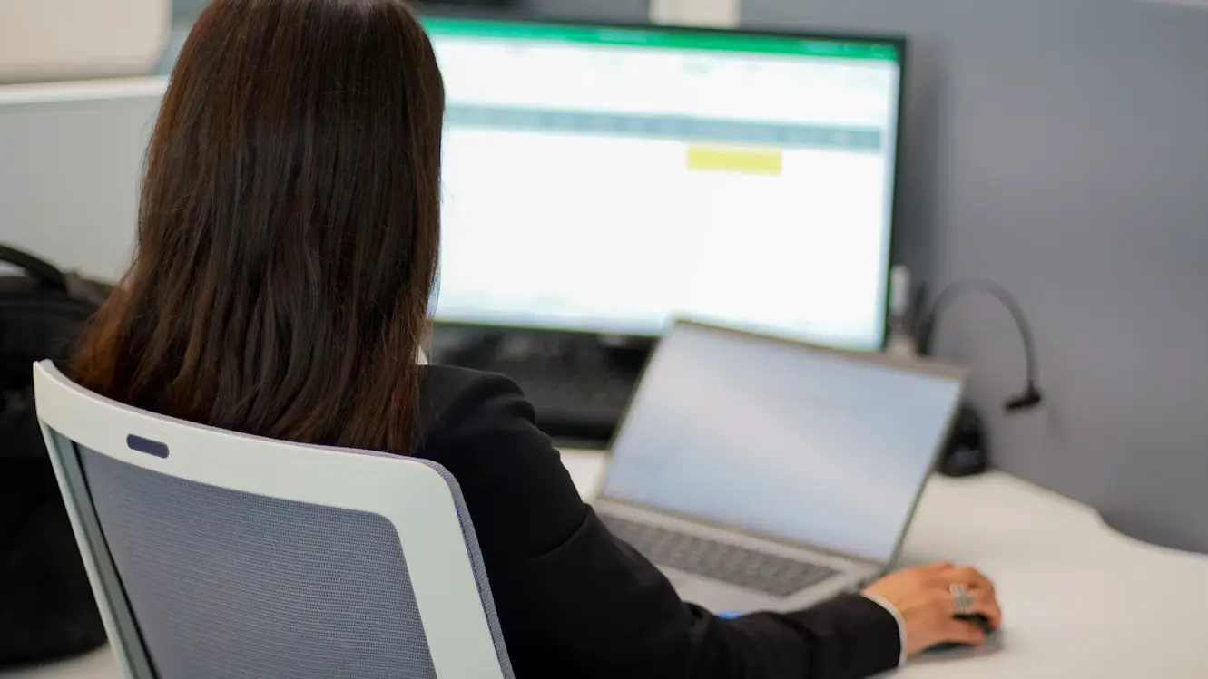 Person working with multiple documents, emails, and spreadsheets at once